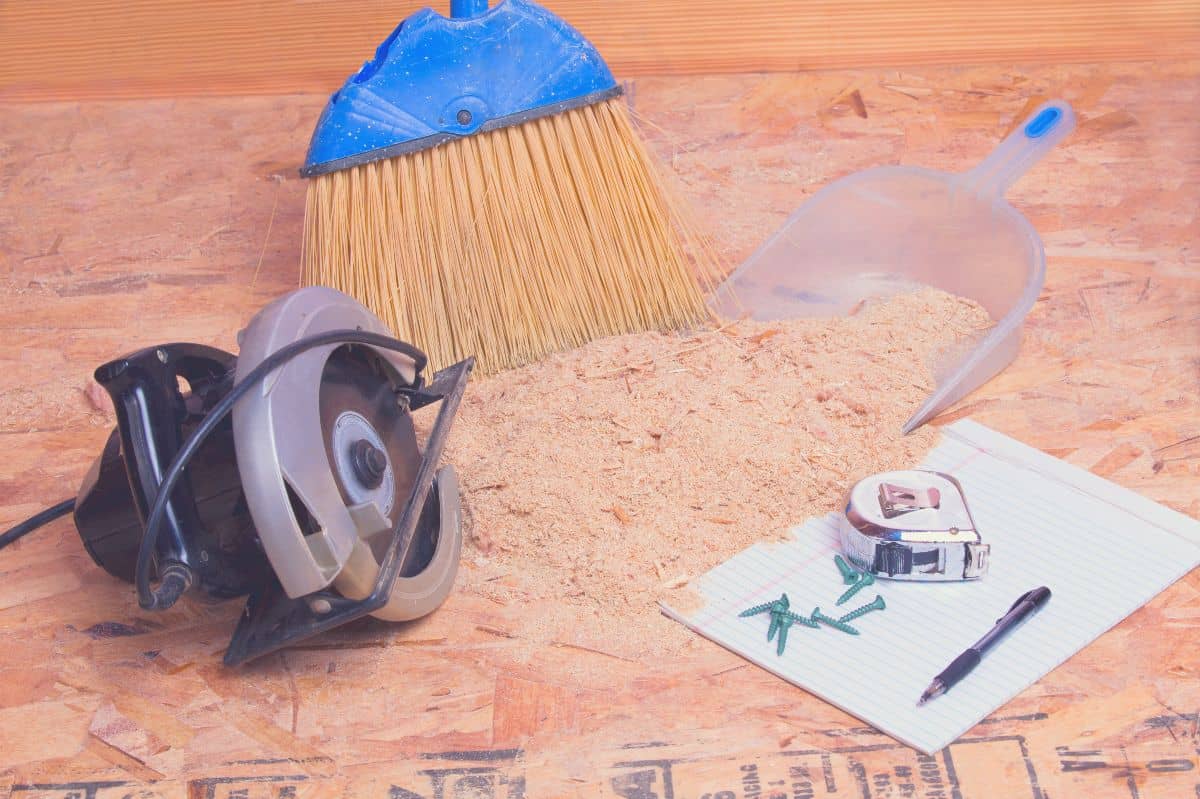 Mini circular saw on the floor surrounded by saw dust